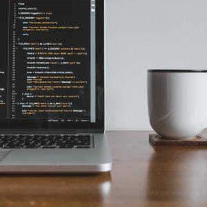 Laptop coding with coffee